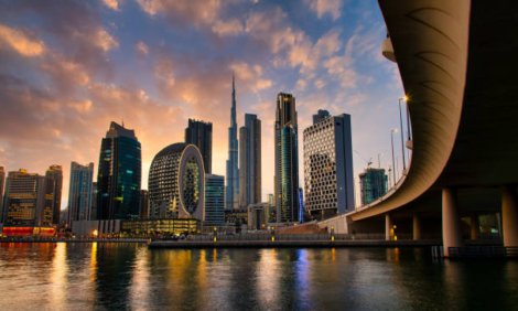 Aerial skyline panorama of downtown Dubai filled with modern skyscrapers in the United Arab Emirates rising above the main city highway aerial view at sunrise